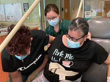 Ana Torres-Soto is helped by her daughter and therapist.