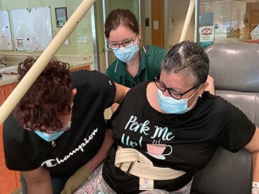 Ana Torres-Soto is helped by her daughter and therapist.