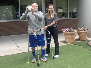James Sauve throws a football in therapy.