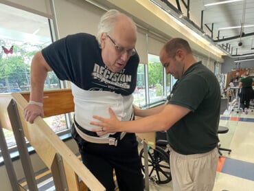 John Nielson works on steps during therapy.